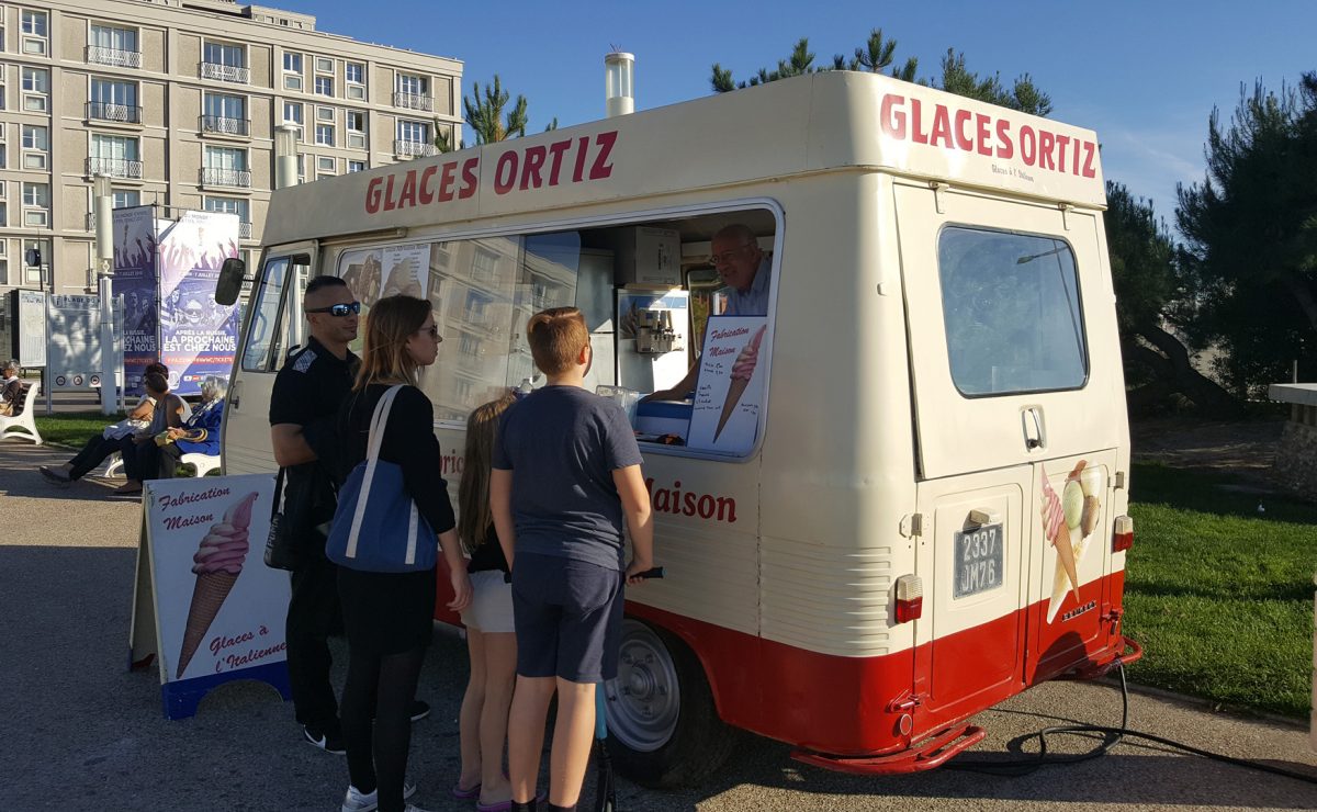 Se rafraîchir avec une glace à la plage Promeneur à la plage achetant une glace au camion Ortiz